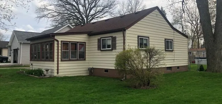 Before: Storm-worn roof restored to a sound, clean finish