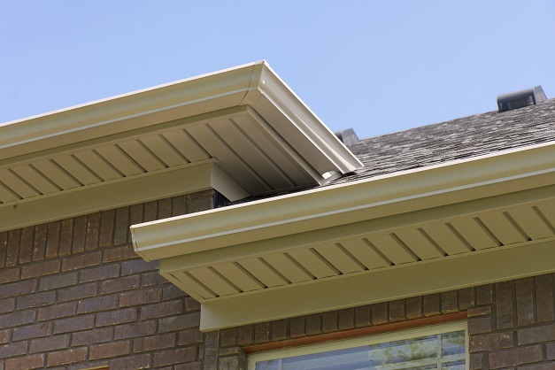 Professionally installed tan colored gutters in Michigan